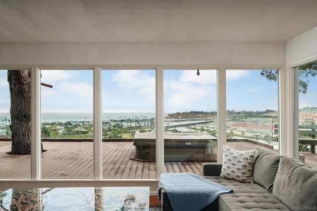 sunroom / solarium featuring a water view