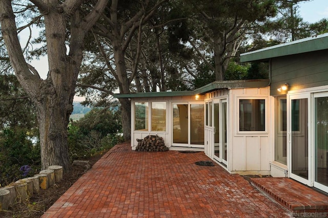 view of patio featuring a sunroom