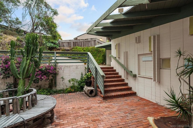 wooden terrace with a patio area