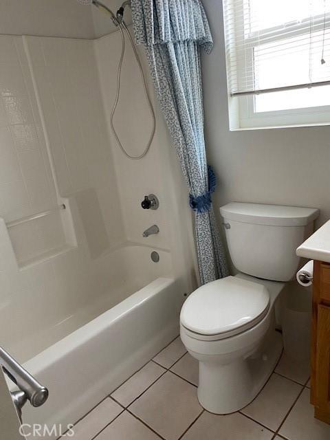 full bathroom with tile patterned flooring, vanity, toilet, and shower / tub combo