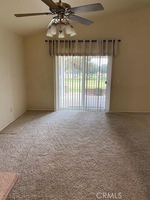 carpeted empty room with ceiling fan