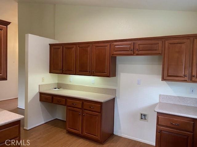 kitchen featuring light hardwood / wood-style flooring and lofted ceiling