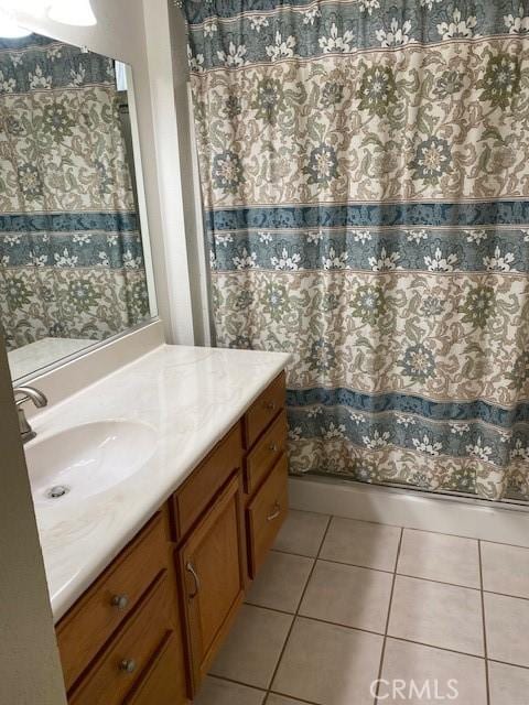 bathroom featuring tile patterned flooring and vanity