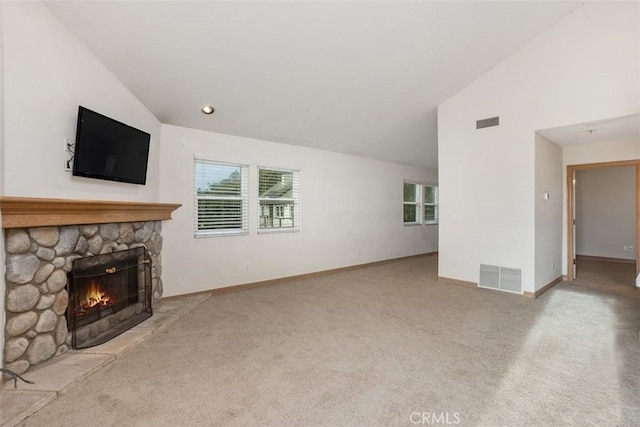 unfurnished living room featuring a stone fireplace, light colored carpet, and high vaulted ceiling