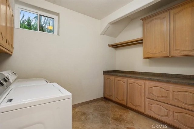 laundry area featuring cabinets and washing machine and clothes dryer