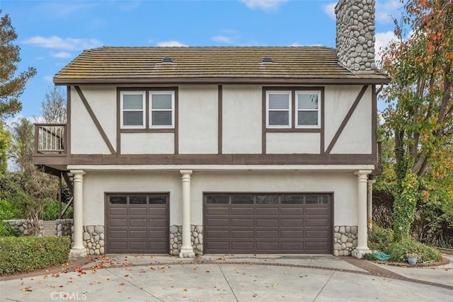 view of front of property featuring a balcony and a garage