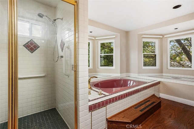 bathroom featuring hardwood / wood-style floors and separate shower and tub