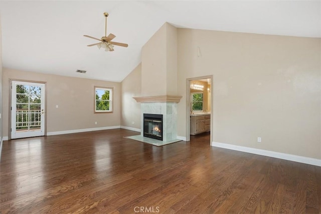 unfurnished living room featuring dark hardwood / wood-style floors, high vaulted ceiling, and a wealth of natural light