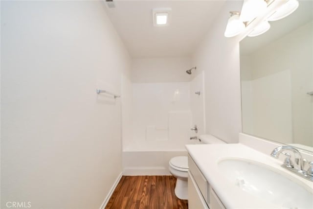 full bathroom with toilet,  shower combination, hardwood / wood-style flooring, and vanity