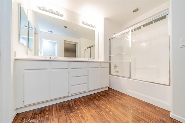 41985 Davenport Way Unit B, Murrieta, CA 92562 - bathroom featuring a sink, visible vents, combined bath / shower with glass door, double vanity, and wood finished floors