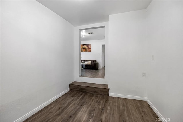 unfurnished room featuring dark wood-type flooring