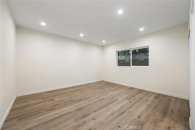 spare room with light hardwood / wood-style flooring