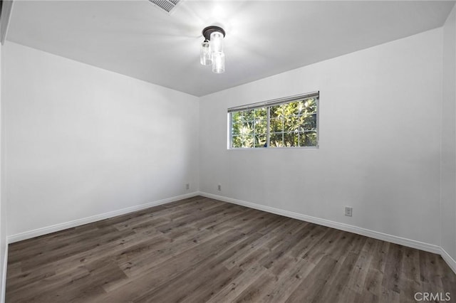 unfurnished room featuring dark hardwood / wood-style floors