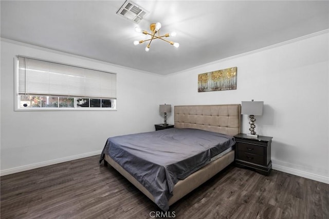 bedroom featuring ornamental molding, dark wood-type flooring, and a chandelier