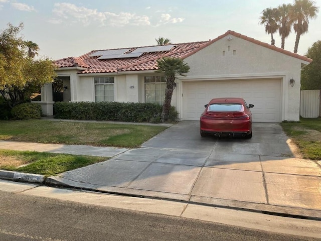 view of front facade featuring solar panels and a garage