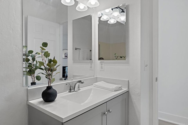 bathroom featuring a textured wall and vanity