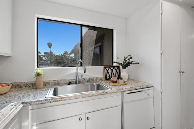 kitchen featuring white dishwasher, a sink, white cabinetry, and light countertops