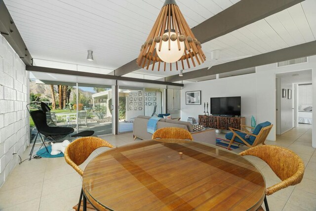 tiled dining room with beamed ceiling