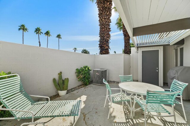 view of patio / terrace with central AC unit and a grill