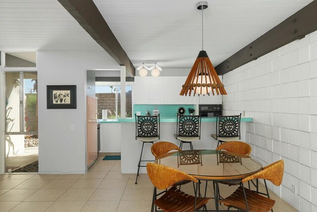 tiled dining area with beam ceiling