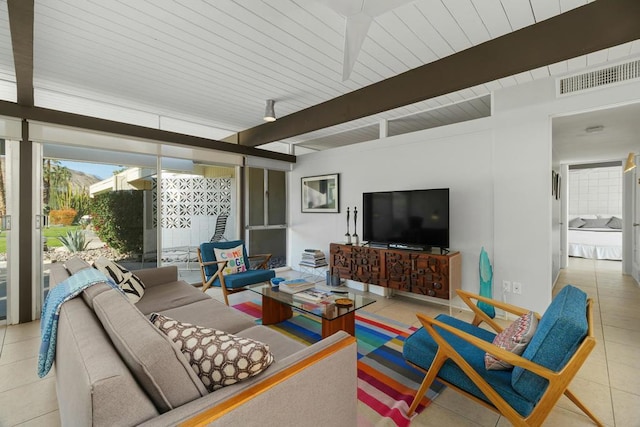 tiled living room featuring beam ceiling