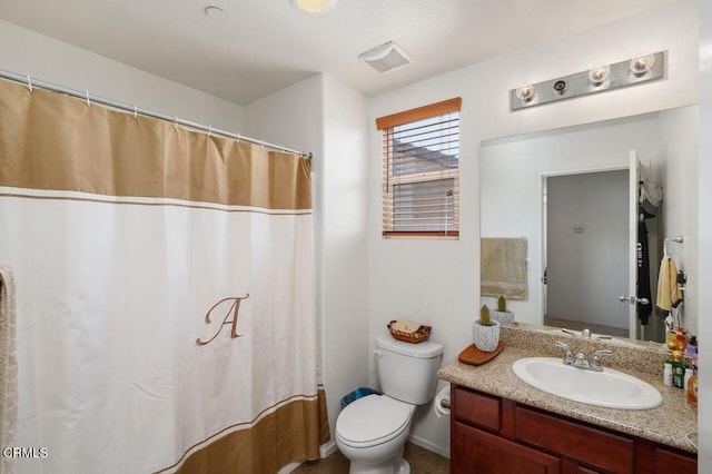 bathroom featuring vanity, toilet, and a shower with shower curtain