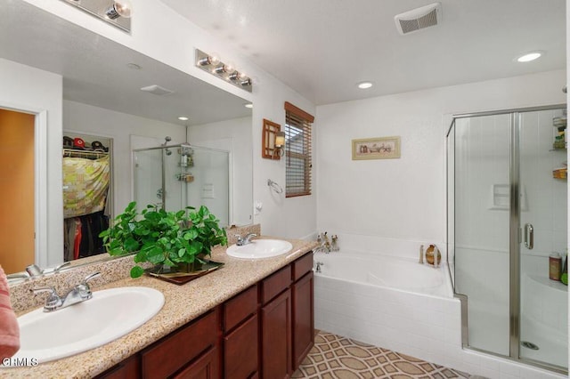 bathroom with vanity, tile patterned floors, and shower with separate bathtub