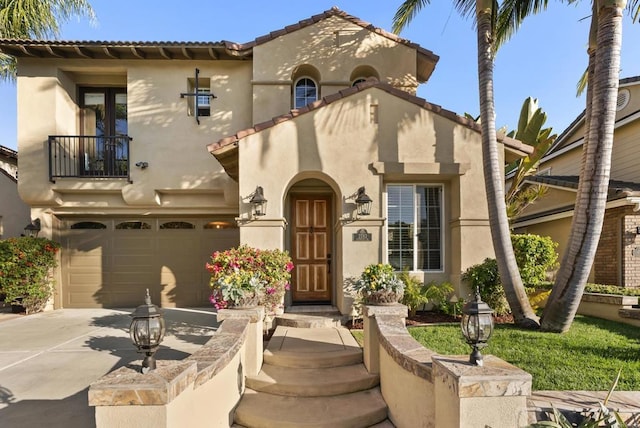 mediterranean / spanish house featuring a garage