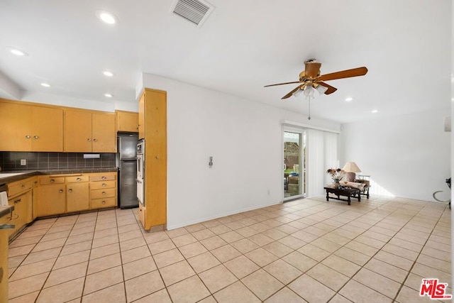 kitchen with ceiling fan, light tile patterned floors, stainless steel refrigerator, and tasteful backsplash