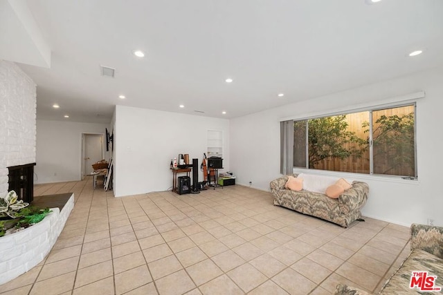 living room featuring a fireplace and light tile patterned flooring