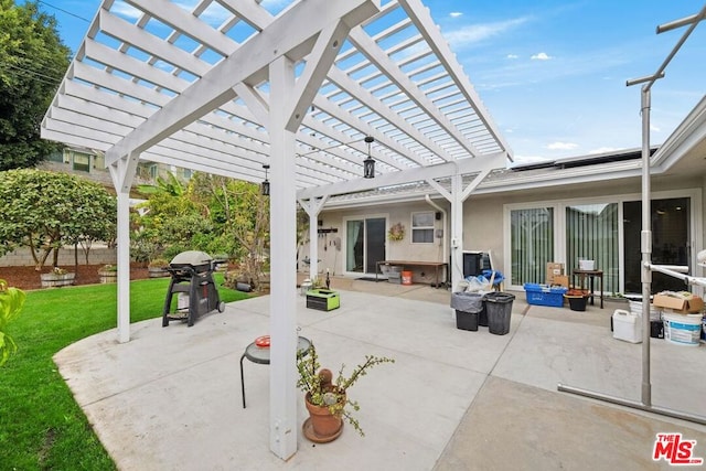 view of patio / terrace with area for grilling and a pergola