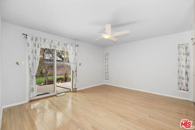 empty room with ceiling fan and hardwood / wood-style flooring