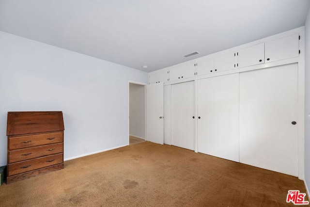 unfurnished bedroom with carpet flooring and a closet