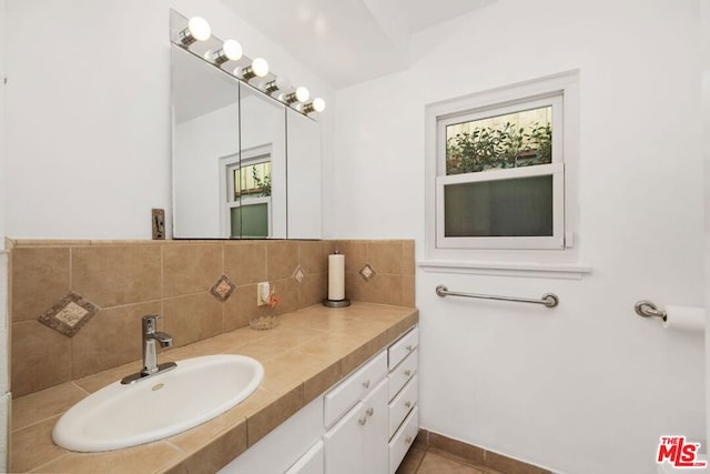 bathroom featuring decorative backsplash, vanity, and tile patterned floors