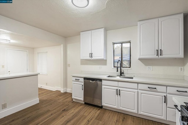 kitchen with white cabinets, appliances with stainless steel finishes, dark wood-type flooring, and sink