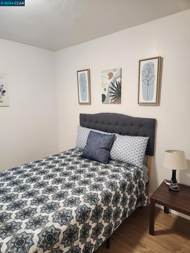 bedroom with wood-type flooring