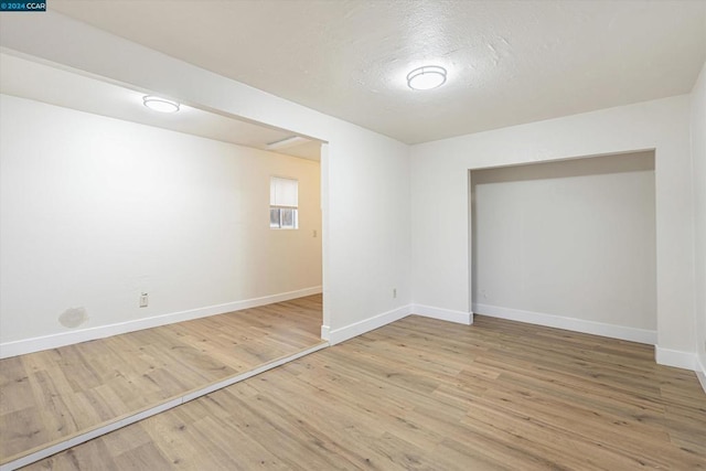 spare room with hardwood / wood-style flooring