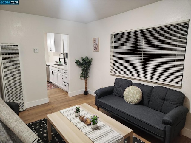 living room with sink and light wood-type flooring