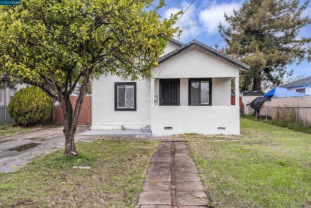 bungalow-style home featuring a front yard