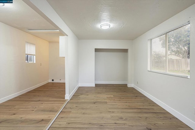 corridor with light wood-type flooring