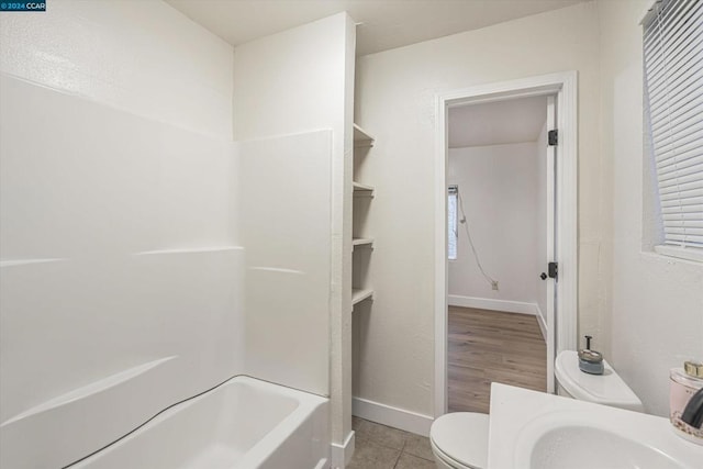 bathroom with tile patterned flooring and toilet