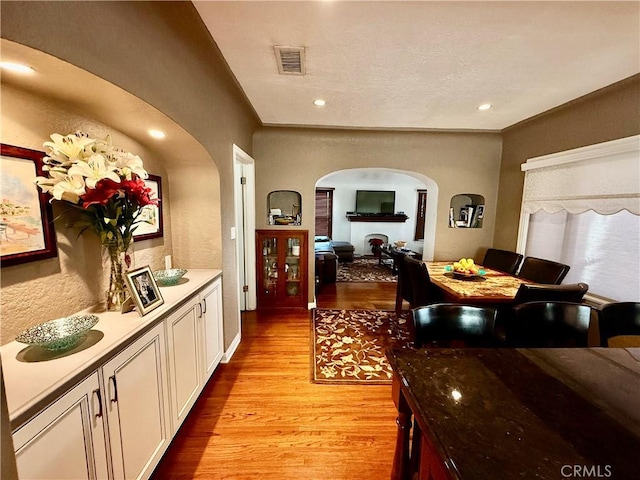 interior space with white cabinetry and light hardwood / wood-style floors