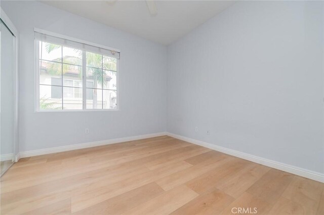 807 Yorkshire, Irvine, CA 92620 - empty room featuring light wood finished floors, a ceiling fan, baseboards, and vaulted ceiling