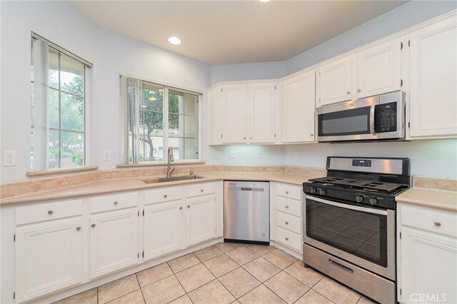 807 Yorkshire, Irvine, CA 92620 - kitchen featuring stainless steel appliances, a sink, white cabinets, light countertops, and recessed lighting