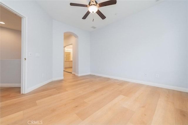807 Yorkshire, Irvine, CA 92620 - unfurnished room with arched walkways, light wood-type flooring, ceiling fan, and baseboards