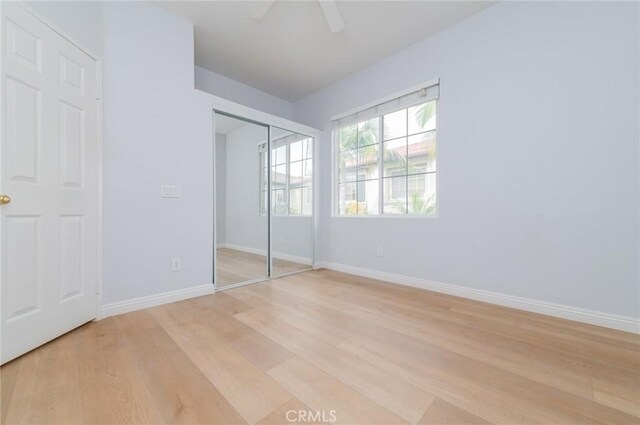 807 Yorkshire, Irvine, CA 92620 - unfurnished bedroom with light wood-style flooring, baseboards, a closet, and ceiling fan