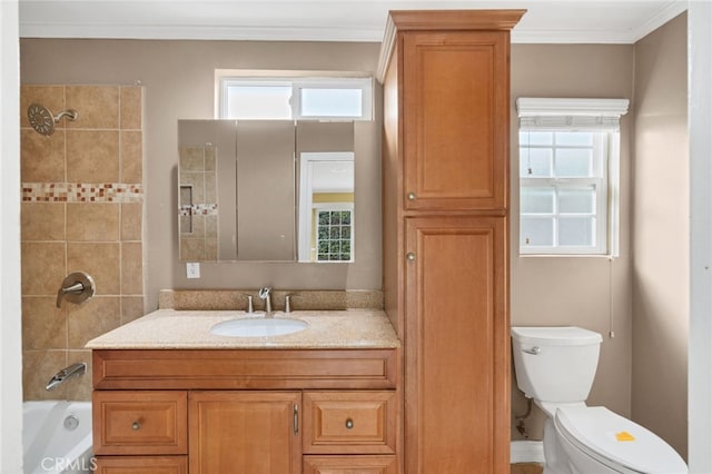 full bathroom with vanity, tiled shower / bath combo, toilet, and ornamental molding