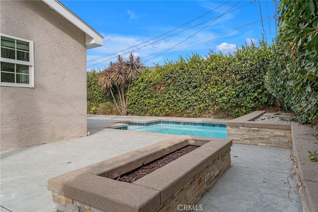 view of swimming pool with a patio