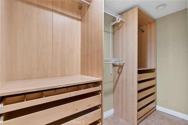 walk in closet featuring light tile patterned floors