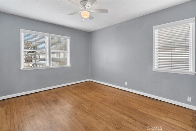 empty room featuring hardwood / wood-style flooring and ceiling fan